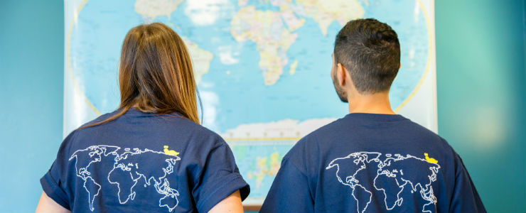 Students looking at world map
